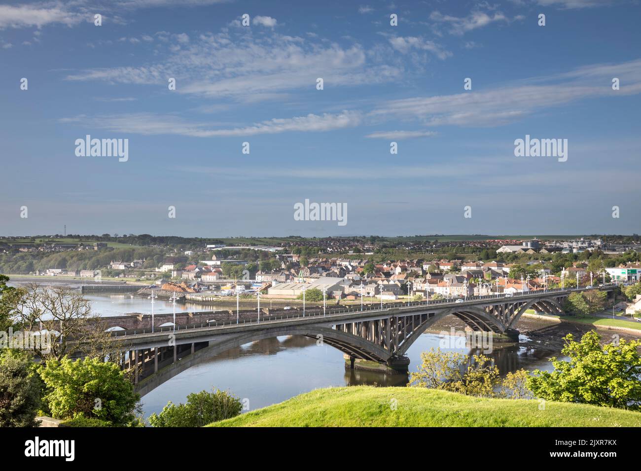 Dating from the 1920s, the Royal Tweed bridge carries road traffic over the river. The older 17th century stone Berwick Bridge can be seen just beyond Stock Photo