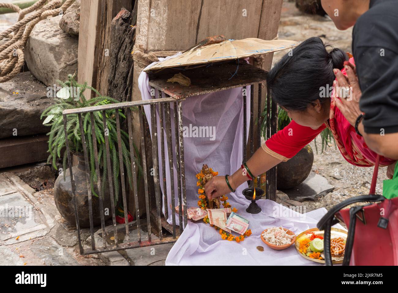 Devotees perform rituals and take blessings from the god of rain during ...