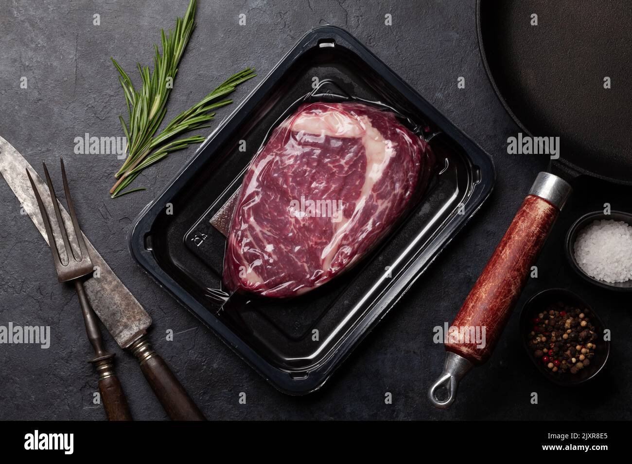 Vacuum packed beef steak. Ribeye steak and cooking utensils. Top view flat lay Stock Photo Alamy