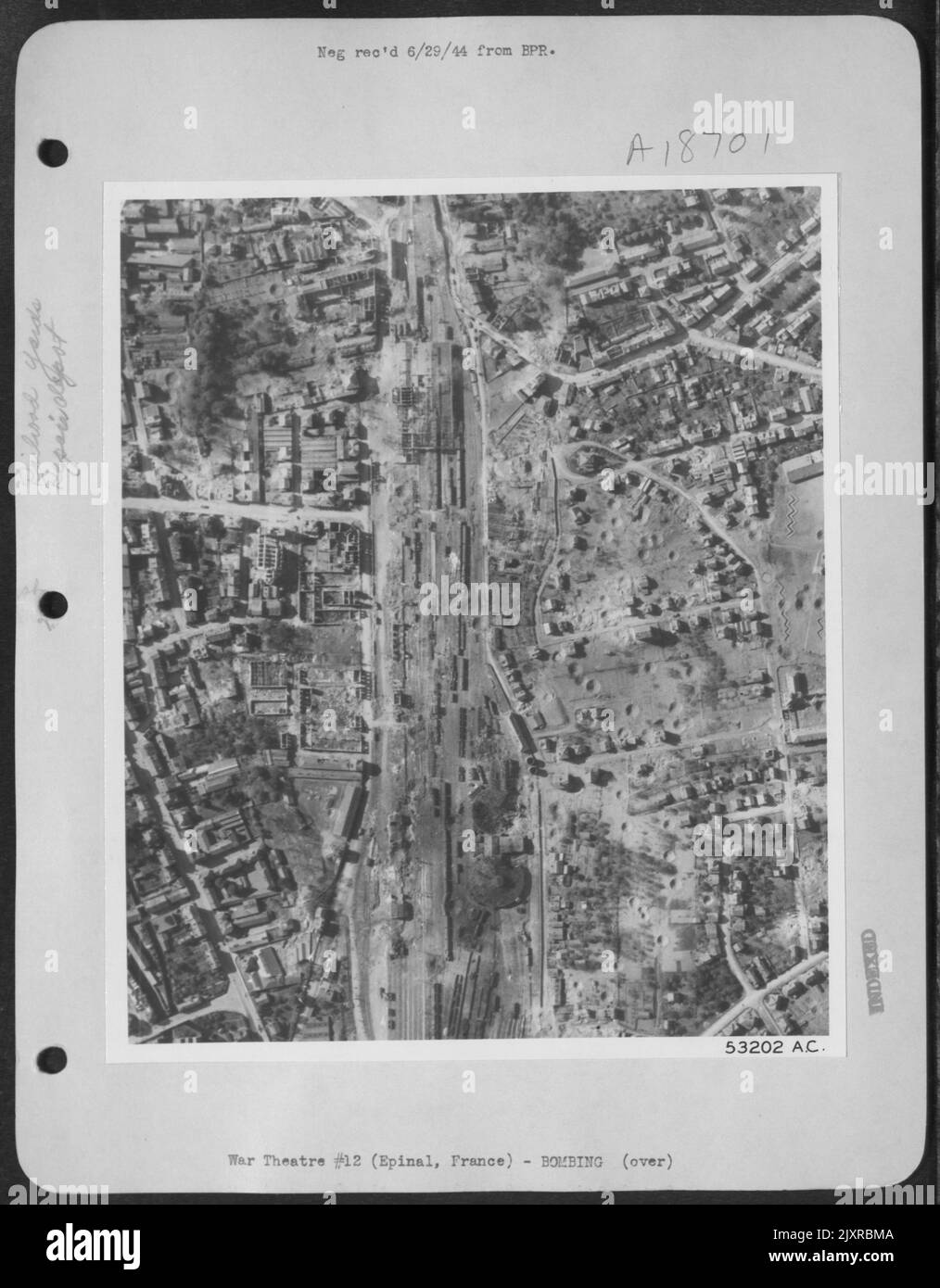 Severe damage to roundhouses, repair shops and adjacent buildings is most evident in this reconnaissance photo of the rail marshalling yards at Epinal, France, taken after the attack by 8th USAAF heavy bombers on 23 May 44. Direct hits partially Stock Photo