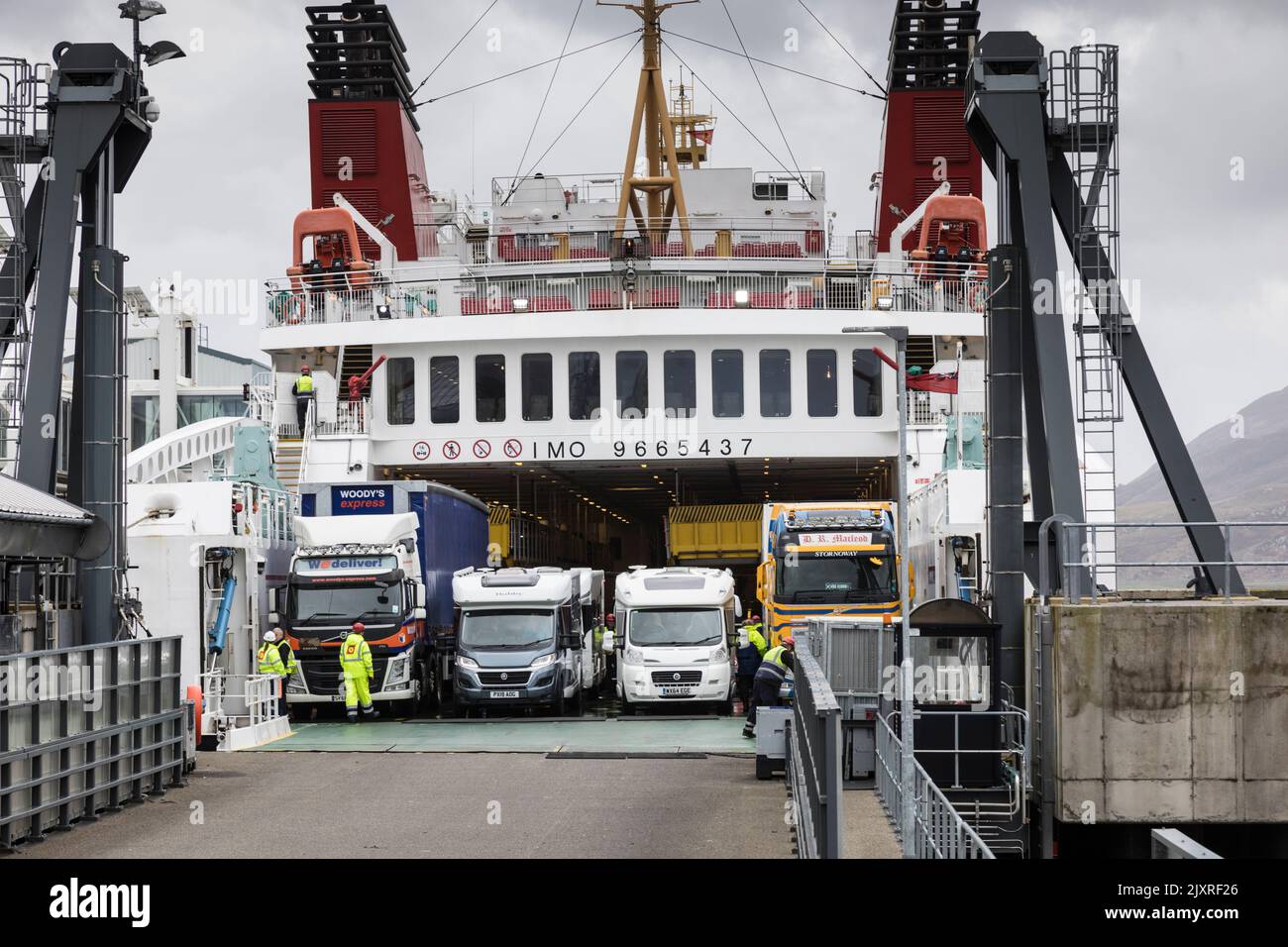 Campervans and lorries prepare to disembark from a CalMac ferry at ullapool harbour, Scotland. Stock Photo