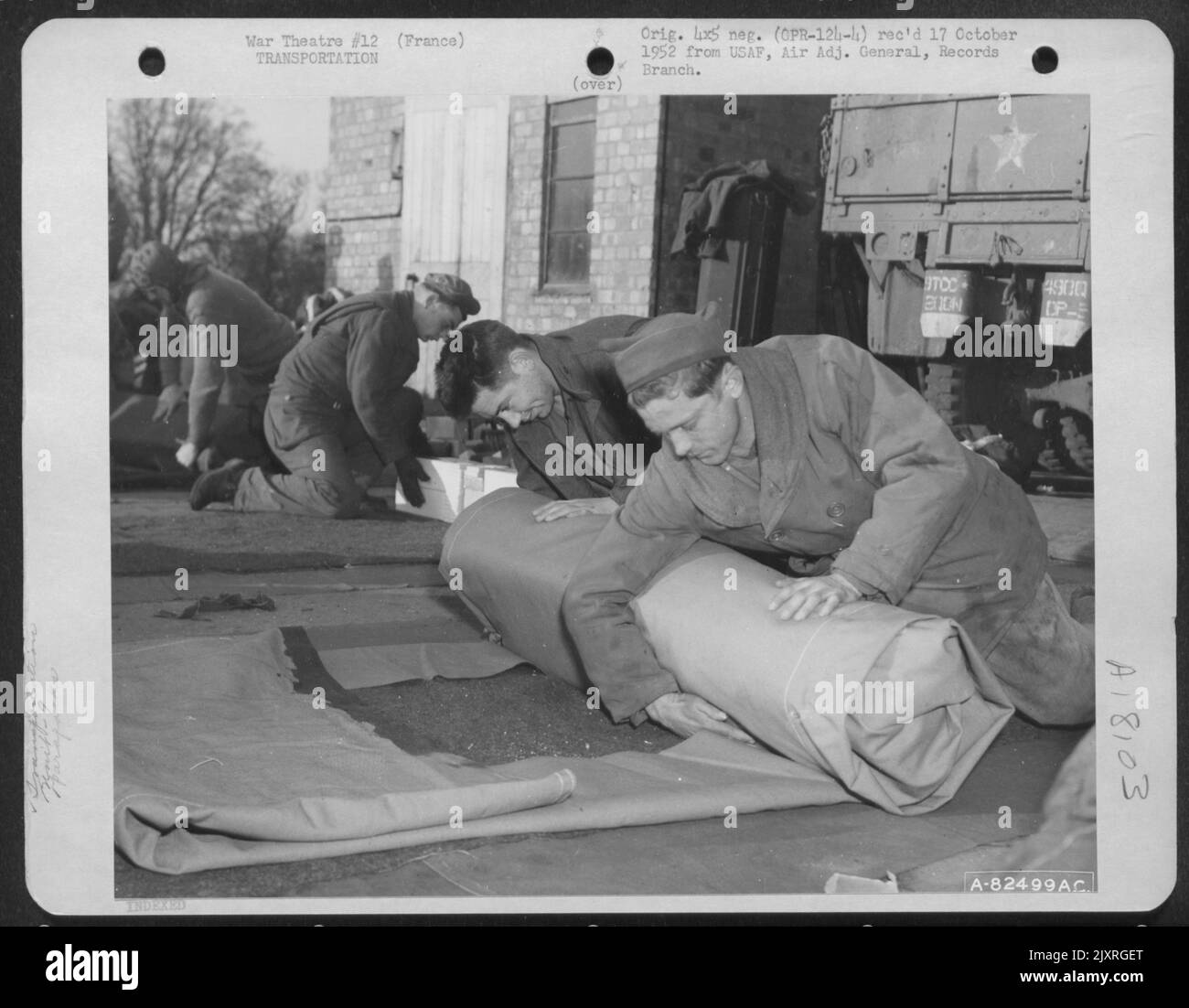Members Of The 9Th Troop Carrier Command Pack Parapacks At An Air Base ...