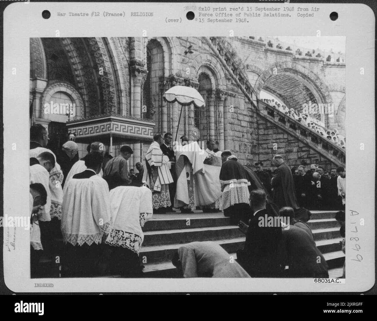 After Parading Through The Streets Of Lourdes, Past Lines Of Sick And Crippled Pilgrims Who Came To The World Famous Shrine Hoping To Be Cured, Worshippers Gather Before Rosary Church, To Receive The Final Blessing By Chaplain (Major ) Stephen A. Tatar Of Stock Photo