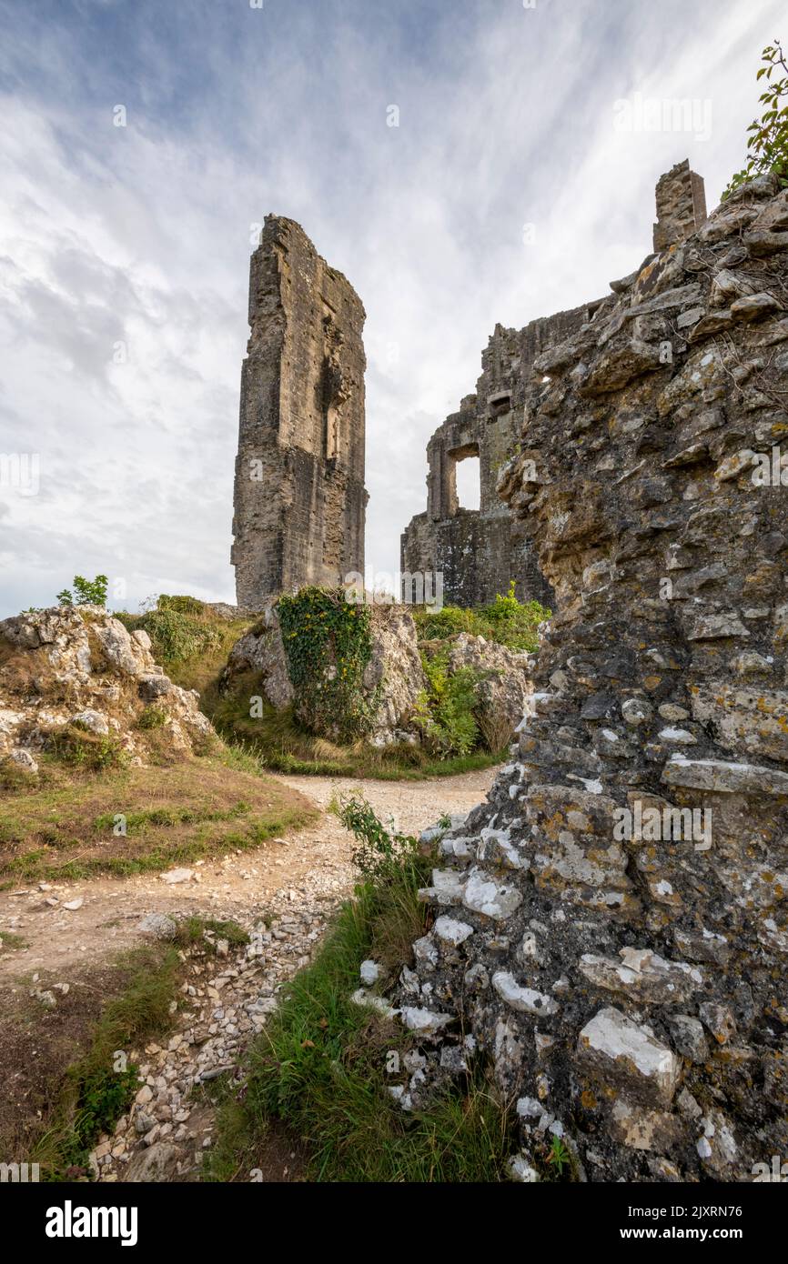 historic remains of the 11th century castle at corfe castle village on the isle of purbeck in dorset, ruined walls and keep at corfe castle in dorset. Stock Photo