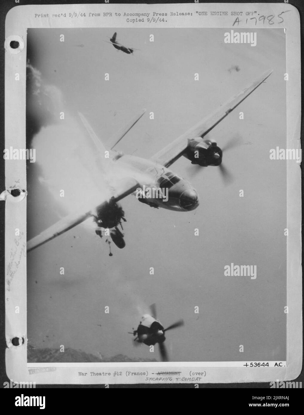 This Martin B-26 Marauder of the 12th U.S. Army Air Force has just received a direct hit by an 88 mm flak shell during an attack on enemy coastal defense guns in Toulon Harbor, southern France. With the right engine sheared off but still turning and Stock Photo