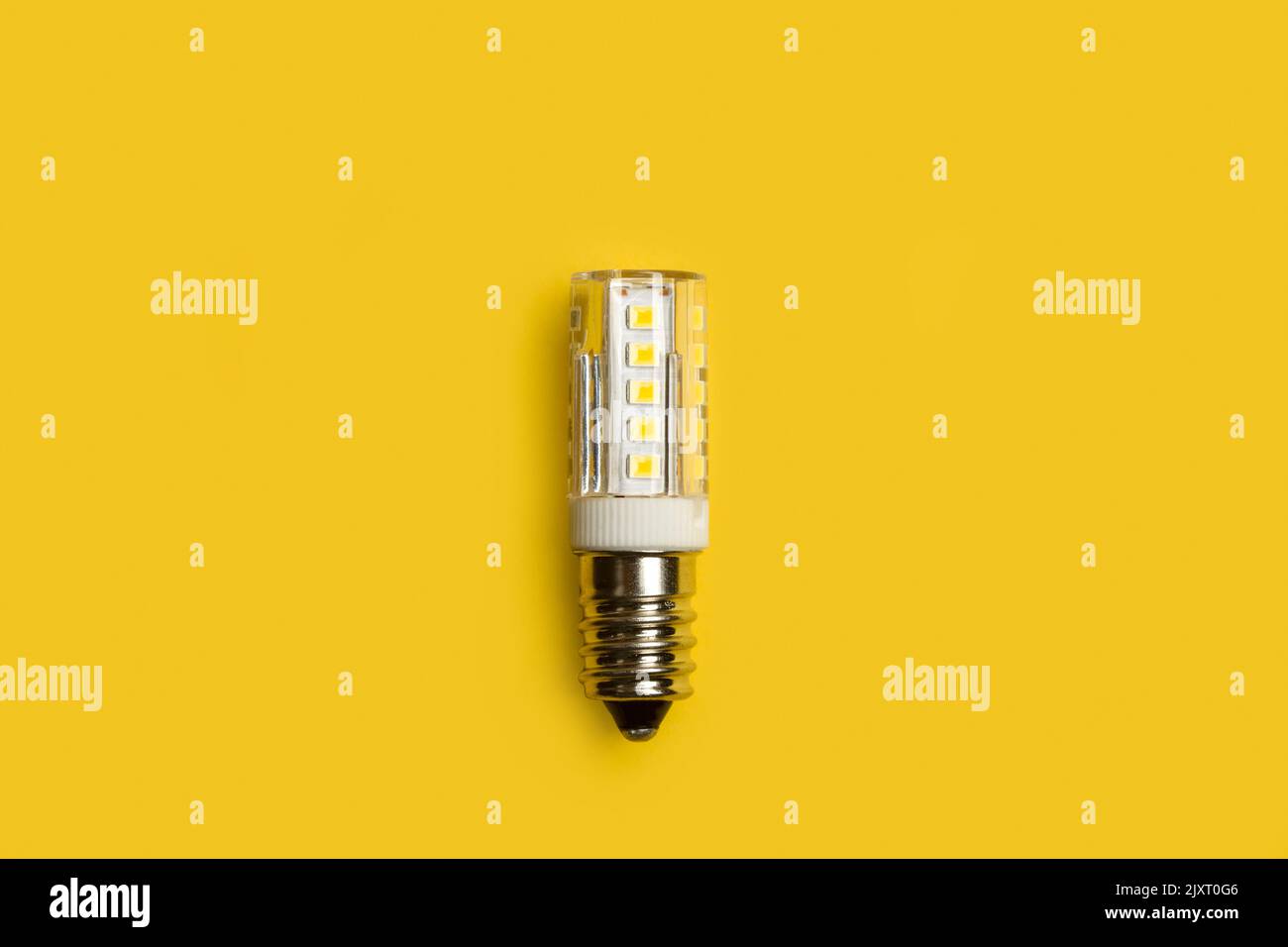Led lightbulb on a yellow background in a close up view Stock Photo