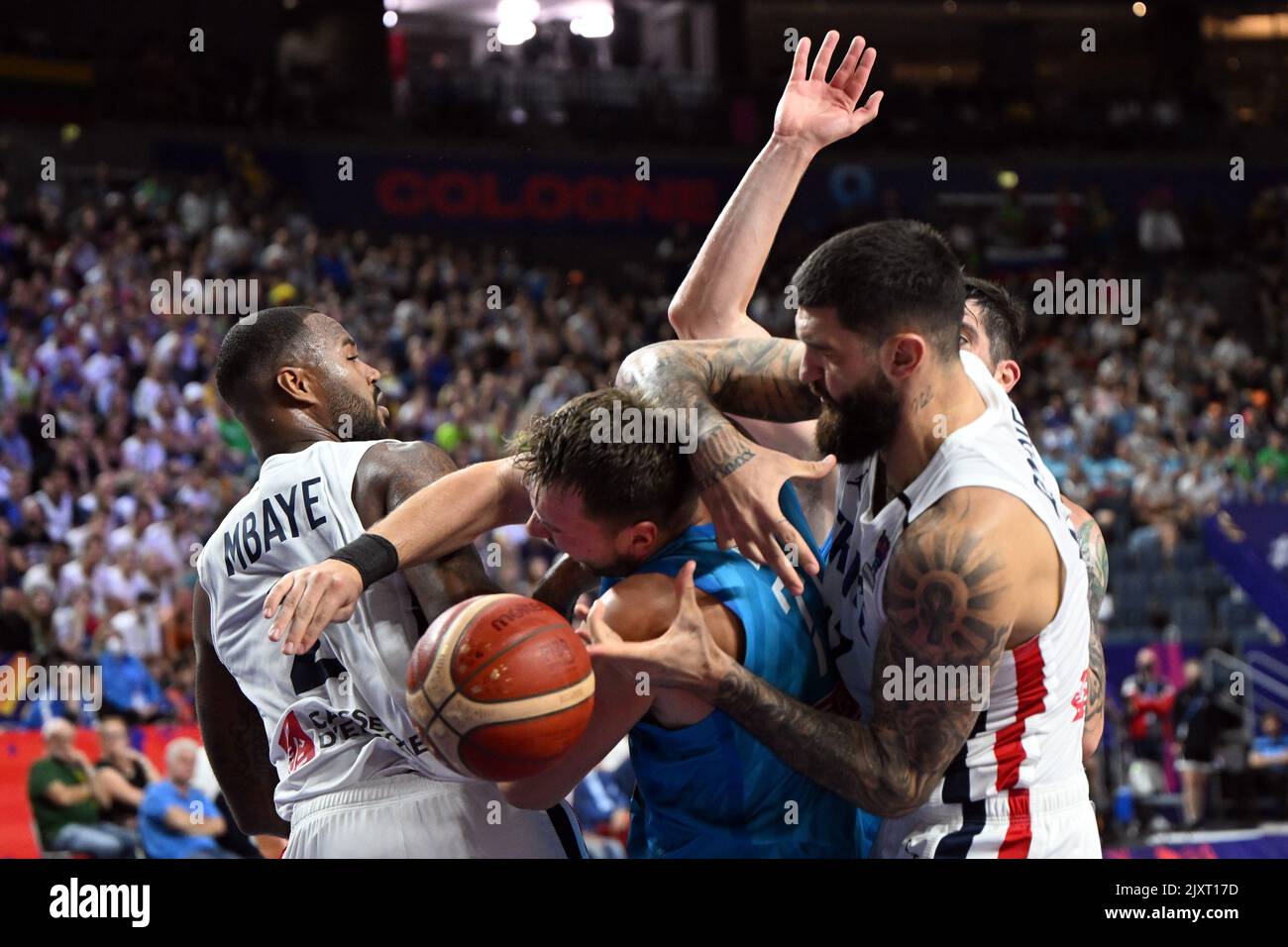 Cologne, Germany. 07th Sep, 2022. Basketball: European Championship, France  - Slovenia, preliminary round, Group B, Matchday 5, Lanxess Arena. France's  Vincent Poirier (r) and Slovenia's Luka Doncic fight for the ball. Luka