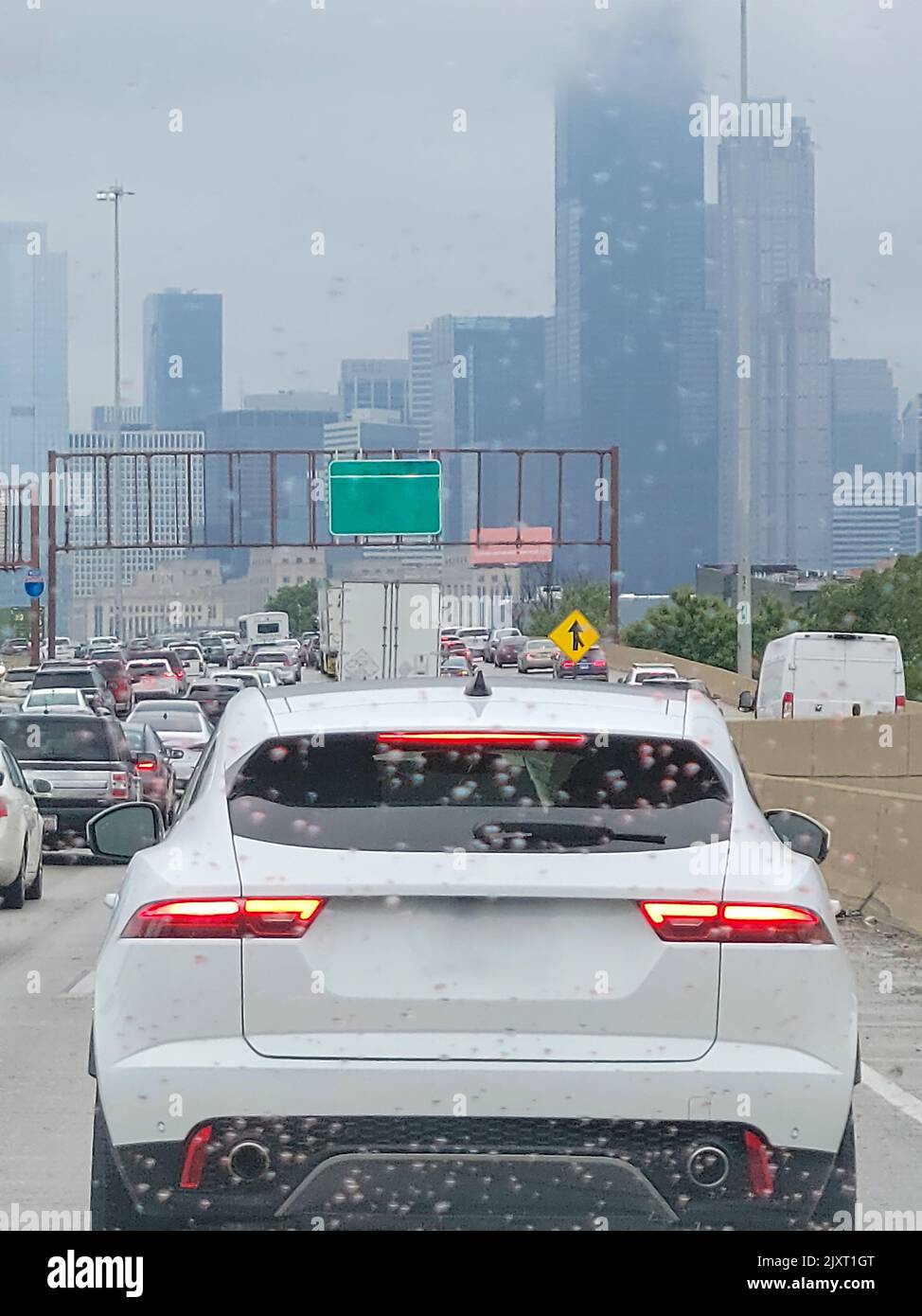 View of congested Chicago city traffic through a windshield with raindrops Stock Photo