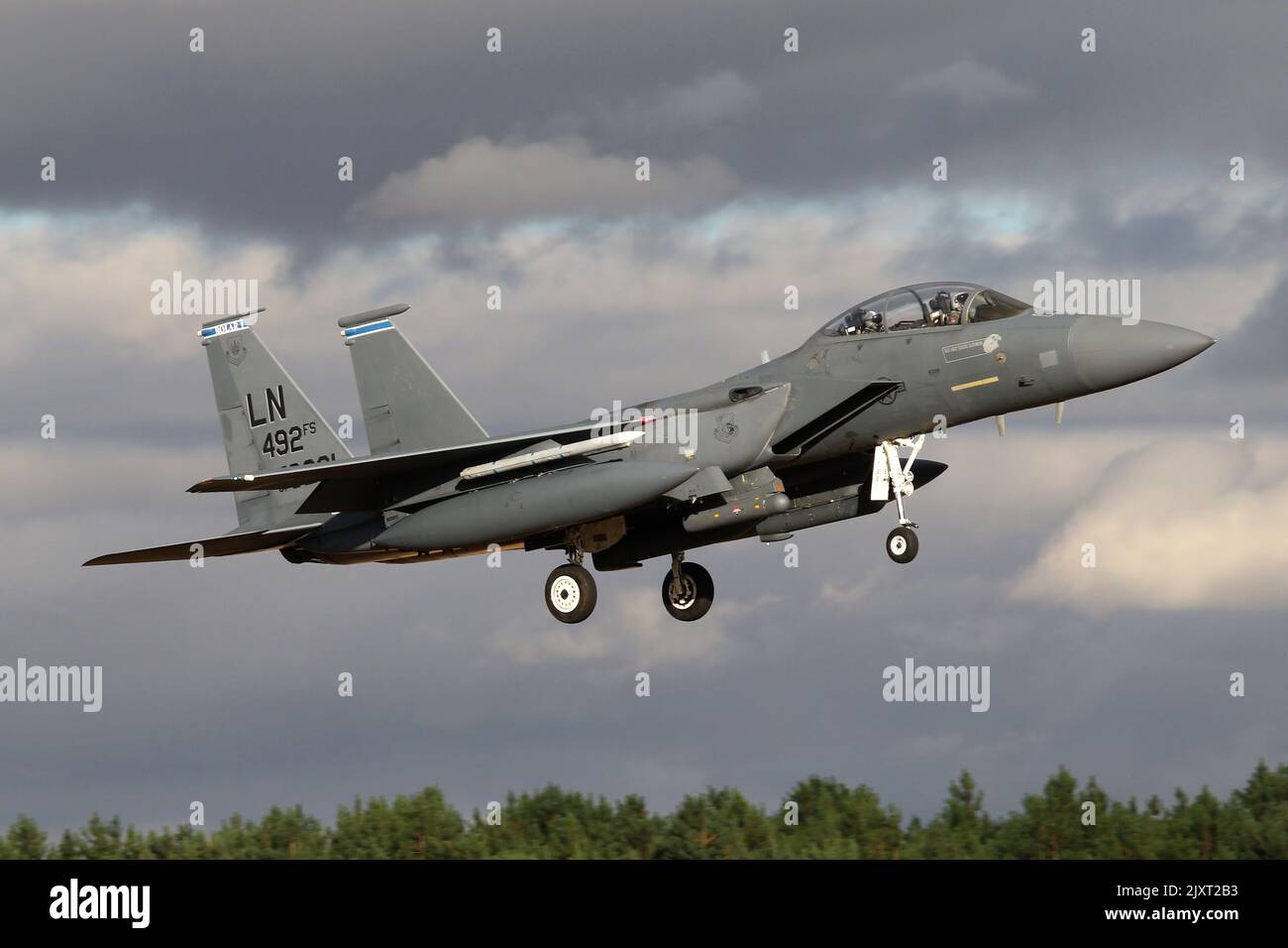 48th Fighter Wing F-15E returning to RAF Lakenheath against a moody sky. Stock Photo