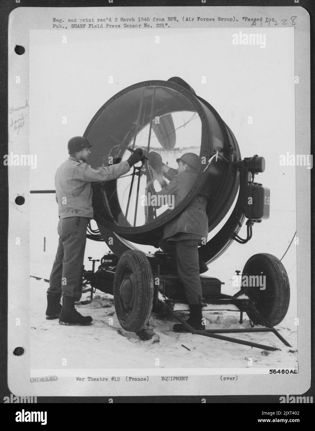 FRANCE--Sgt. Arthur Grahame, Akron, Ohio, left, and Pvt. James Nolin, Columbus, Ga., change carbons during a general check-up of their searchlight. To insure peek operational efficiency at night, the light is checked daily. Stock Photo