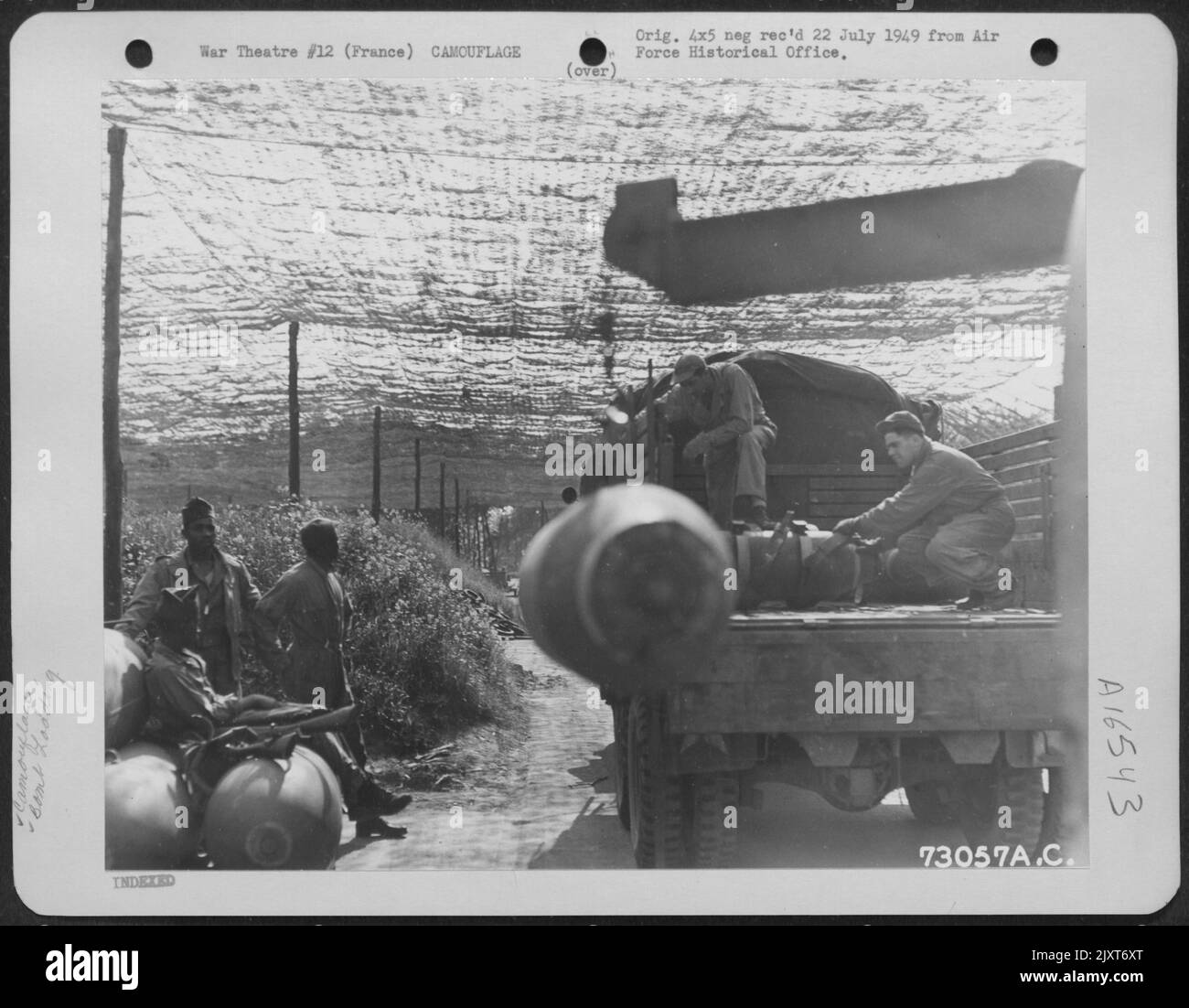 Enlisted Men Load Bombs Onto A Truck At A Camouflaged Bomb Dump, France ...