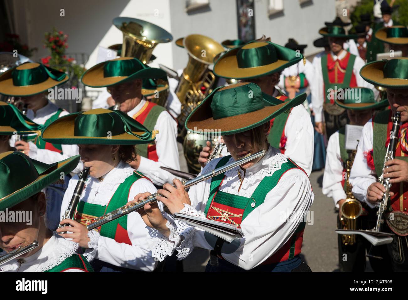 Men and women musicians wearing traditional local period costume of wide brimmed hats and leather breeches or long skirts, 'Corpus Christi' parade. Stock Photo
