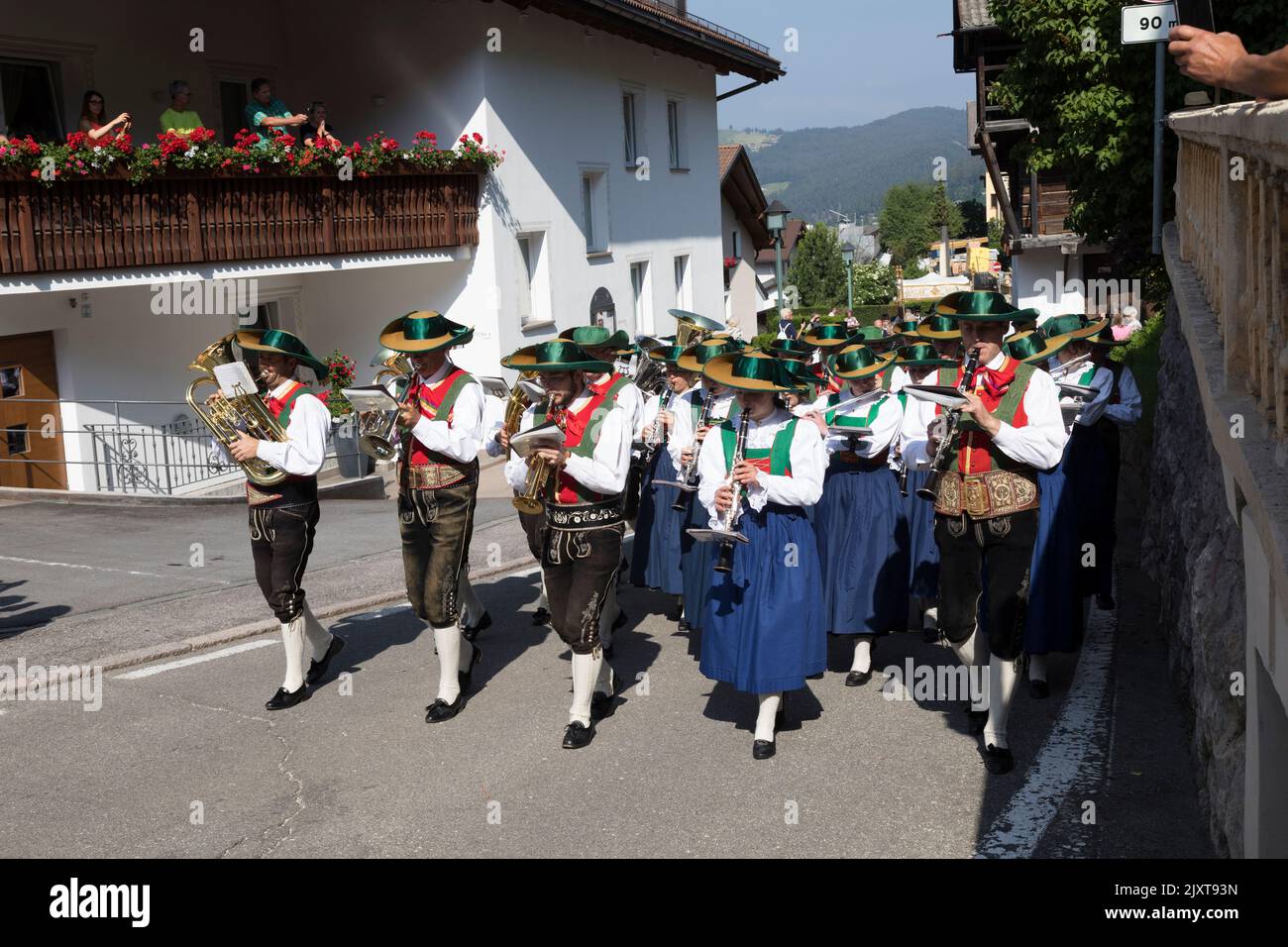 Men and women musicians wearing traditional local period costume of wide brimmed hats and leather breeches or long skirts, take part in a 'Corpus Chri Stock Photo
