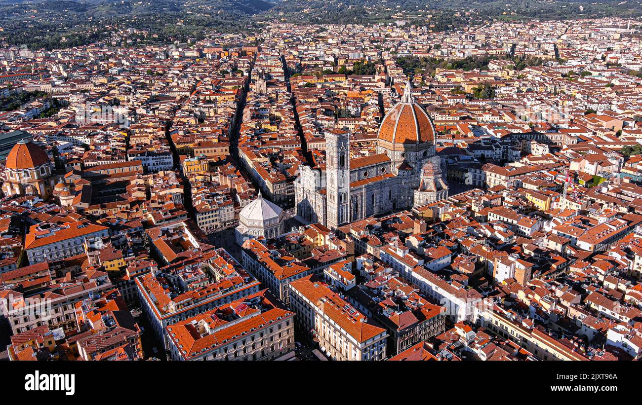 Cathedral of Santa Maria del Fiore aerial drone view in Florence, Italy.  Red-tiled dome, colored marble facade ft. elegant Giotto Tower around Piazza Stock Photo