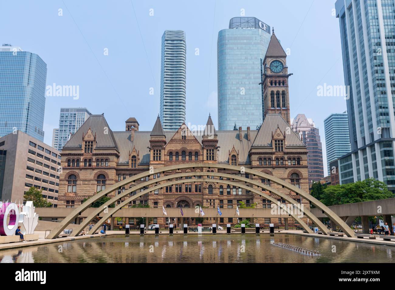 Toronto, Ontario, Canada - July 19 2021 : Fountain at Nathan Phillips Square. Toronto Sign. Toronto Old City Hall. Stock Photo