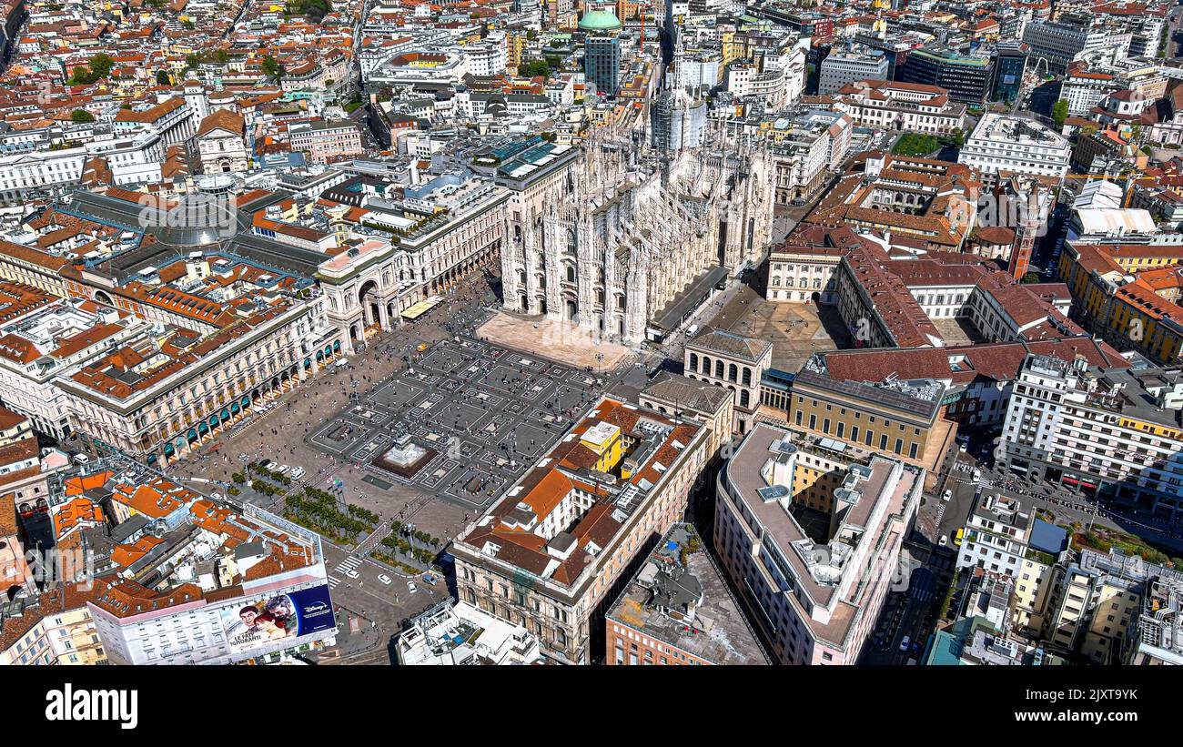 Panoramic aerial view of Duomo di Milano and Piazza Duomo in Milan City, Italy. Flying by The Milan Cathedral is famous landmark and gothic church Stock Photo