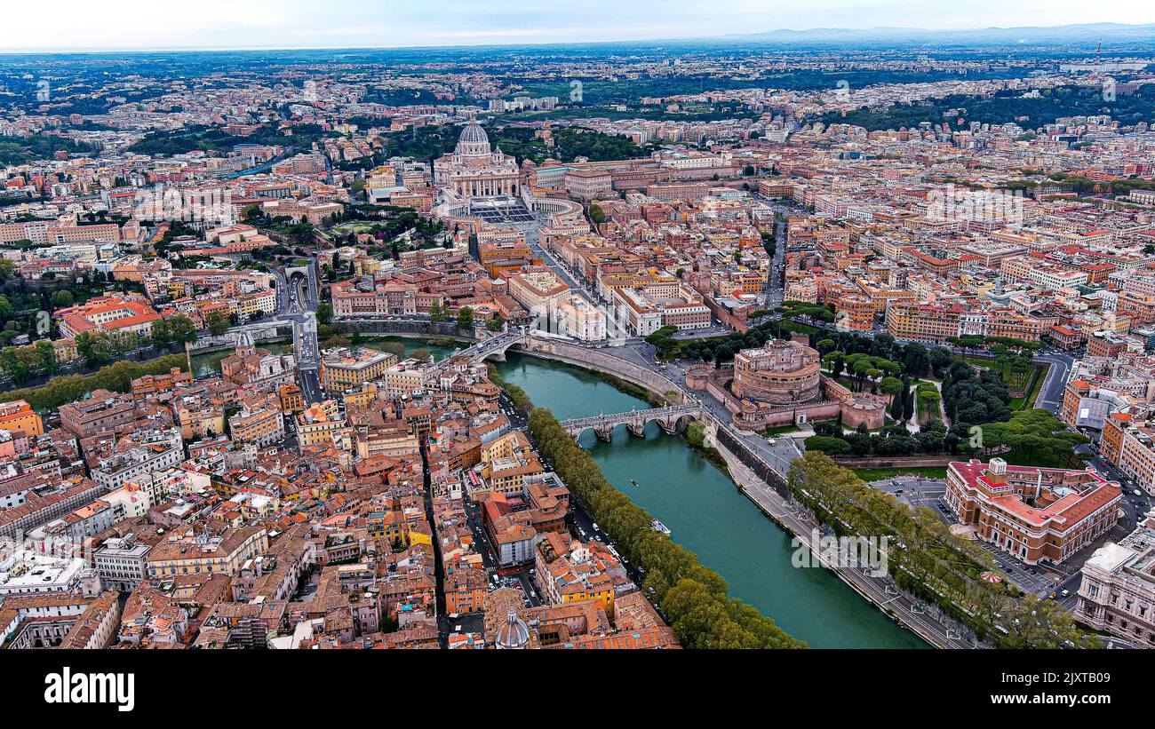 St. Peter's Basilica in Vatican City and Rome city aerial skyline in Italy feat. beautiful old historic cityscape of European Roma drone point of view Stock Photo