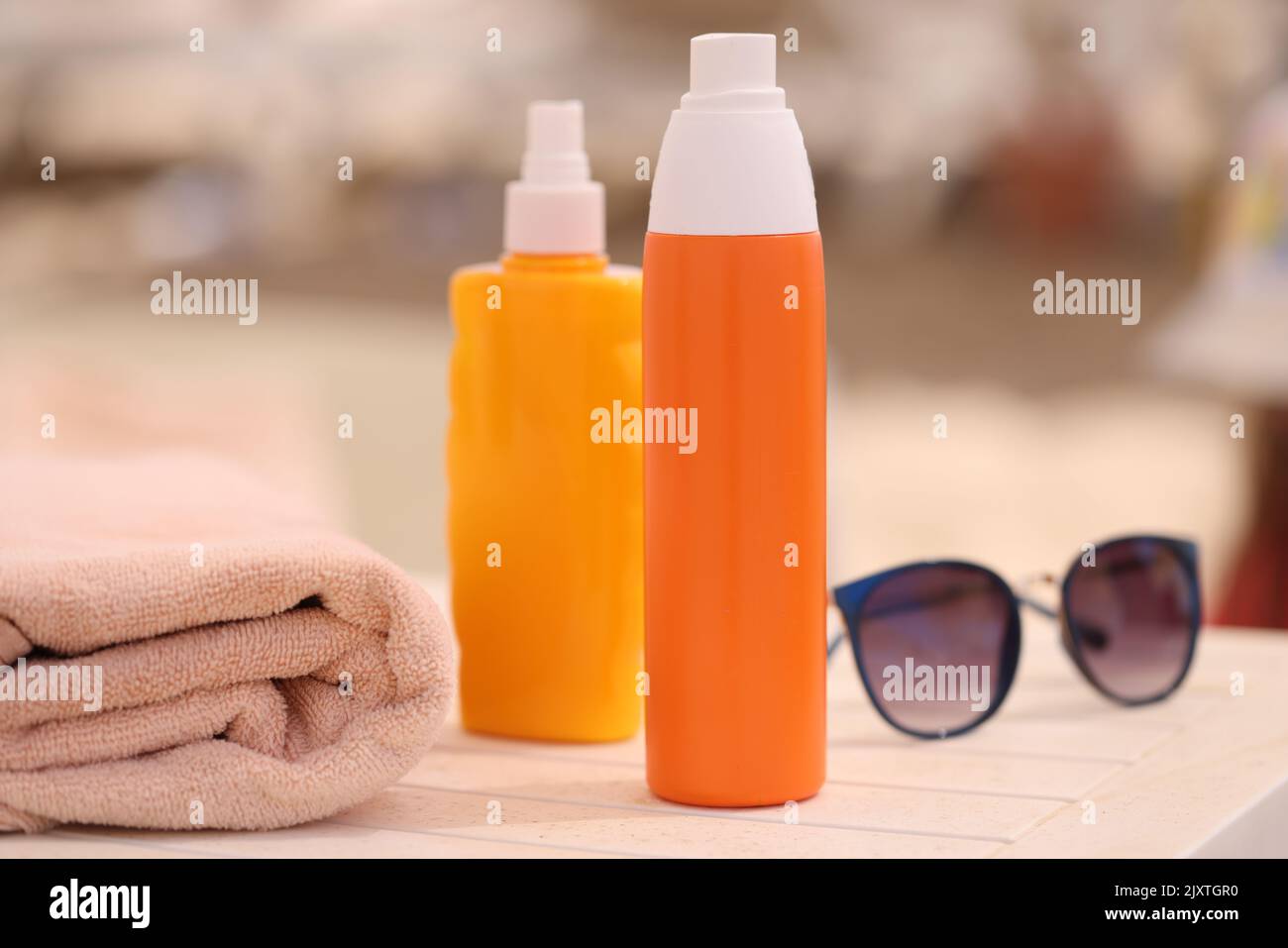 Set of different sunscreen sunglasses and towel closeup Stock Photo Alamy