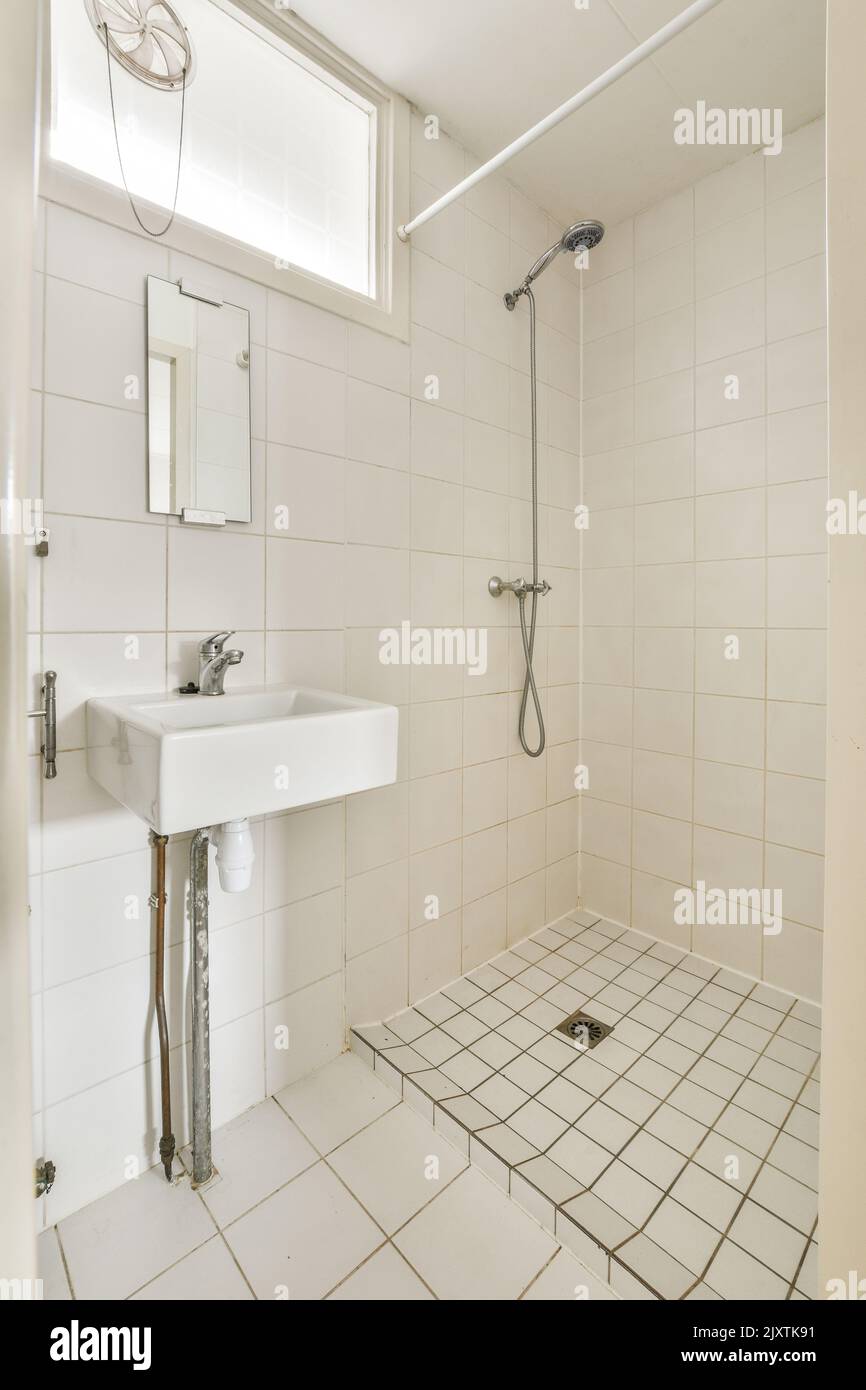 Flush toilet and shower cabin with curtain located near sink and mirrow