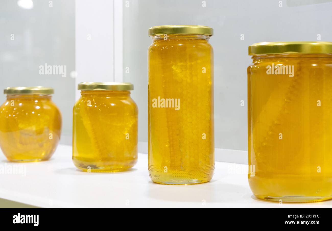Honey in glass jars on the white background Stock Photo Alamy