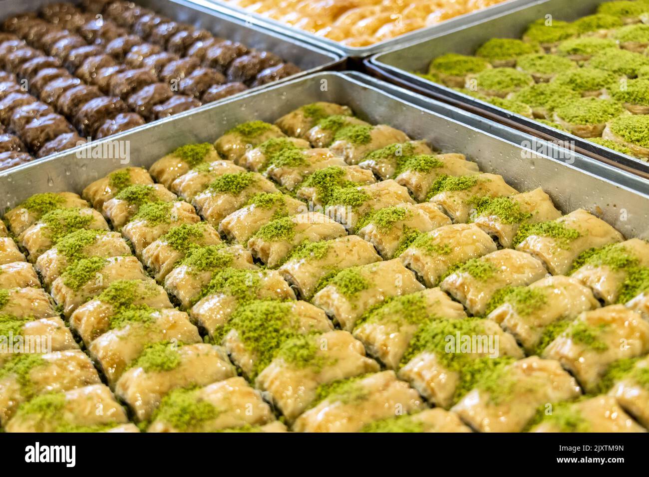 Turkish and Middle Eastern dessert, Local name: Baklava.  Pistachio dough desserts in the tray Stock Photo