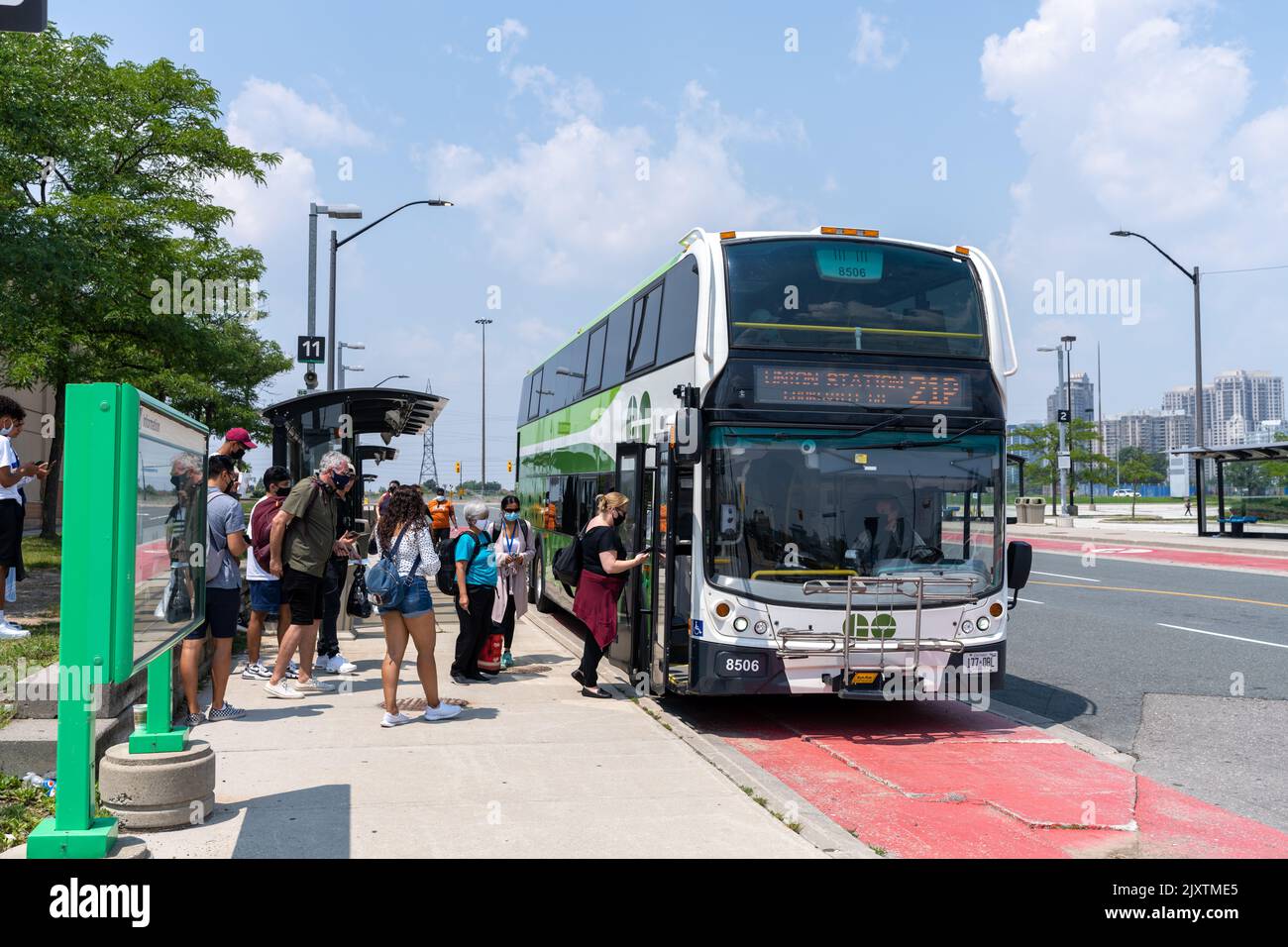 People lining up to board GO Bus at Square One Bus Transit Terminal. Mississauga, Ontario, Canada Stock Photo