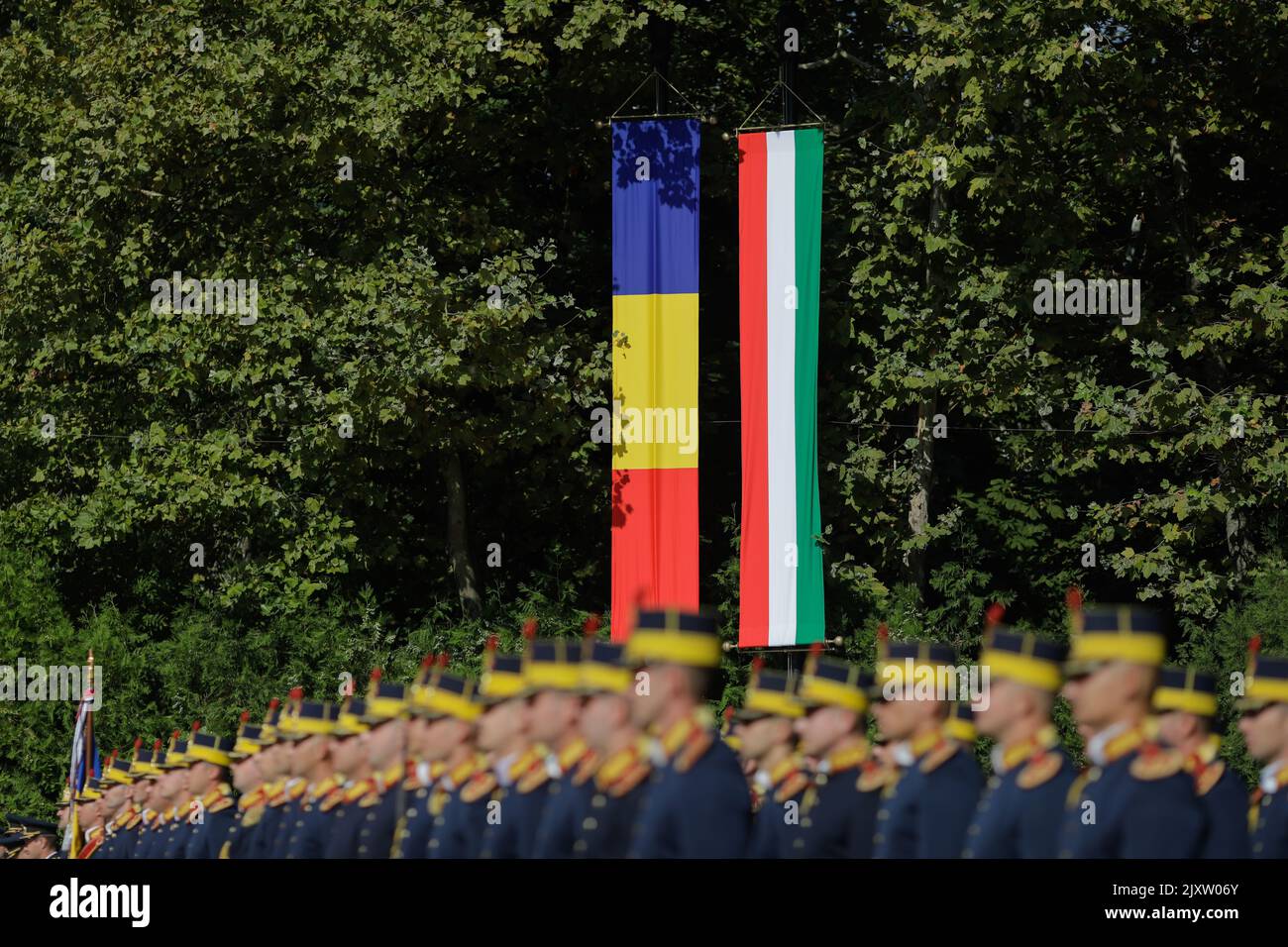 Romanian and Hungarian national flags during a public event. Stock Photo