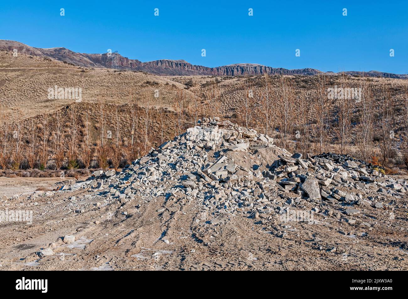 A pile of broken concrete and rocks in a large solidwaste active