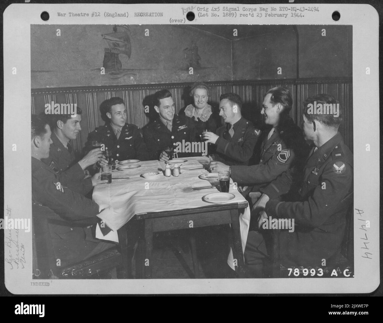 These Crew Members Of The Consolidated B-24 'Shoot Luke' Which Has Had 27 Missions Over Enemy Territory, Enjoy Refreshments In London, England After A Broadcast To The States. They Are, Left To Right, Sgt. George W. Foster Of Akron, Ohio, Waist Gunner; T Stock Photo