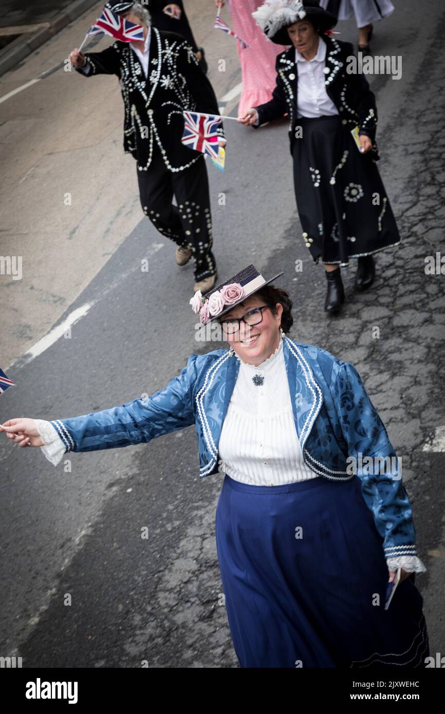 Woman in 'dress through the ages' costume as part of a Platinum Jubilee parade through Haslemere. Stock Photo