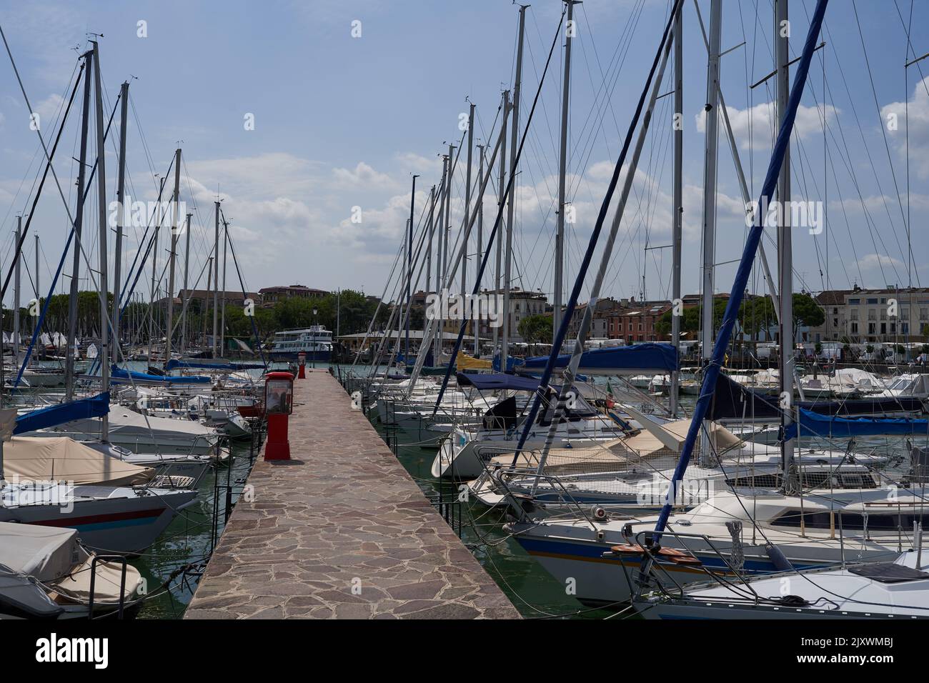 Desenzano del Garda, Italy - July 12, 2022 - yachts and boats docked at the port on Lake Garda on a sunny summer morning Stock Photo