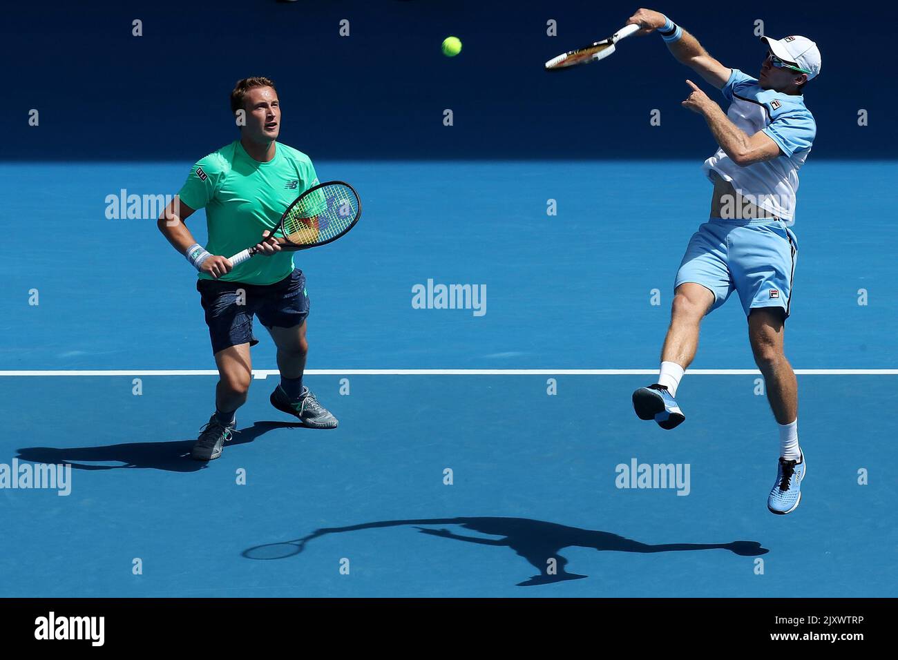 Henri Kontinen of Finland (left) and John Peers of Australia in action  against Pierre-Hugues Herbert of France and Nicolas Mahut of France during  the men's doubles final on day fourteen of the