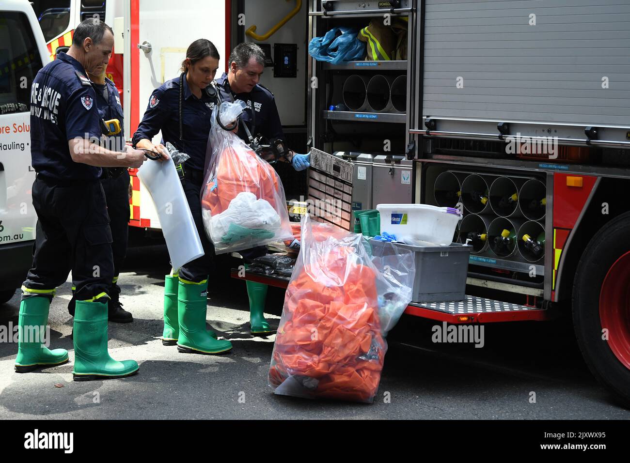 NSW Fire and Rescue workers pack up hazmat material outside 52 Martin ...