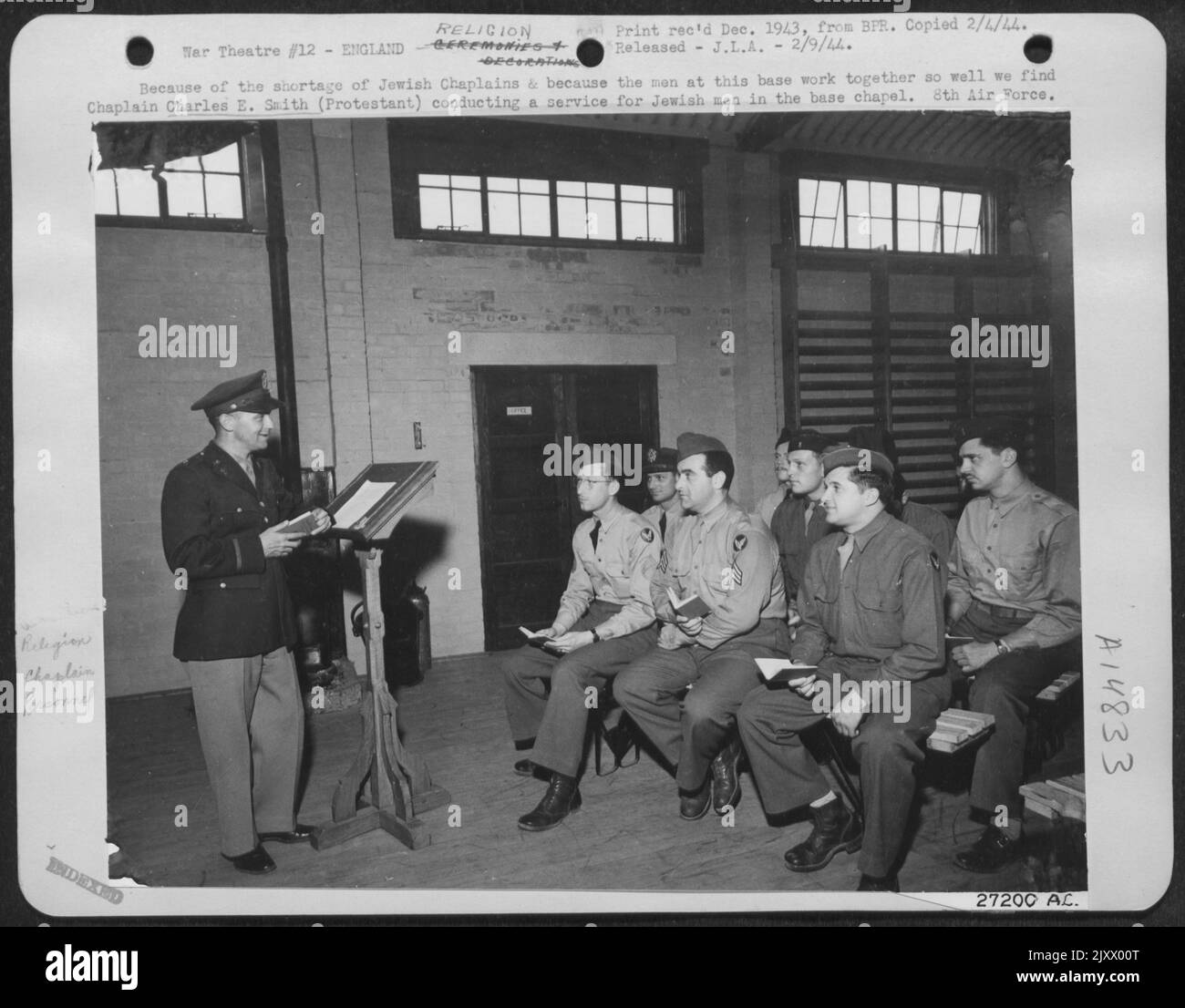 Because of the shortage of Jewish Chaplains & because the men at this base work together so well we find Chaplain Charles E. Smith (Protestant) conducting a service for Jewish men in the base chapel. 8th Air force. Stock Photo
