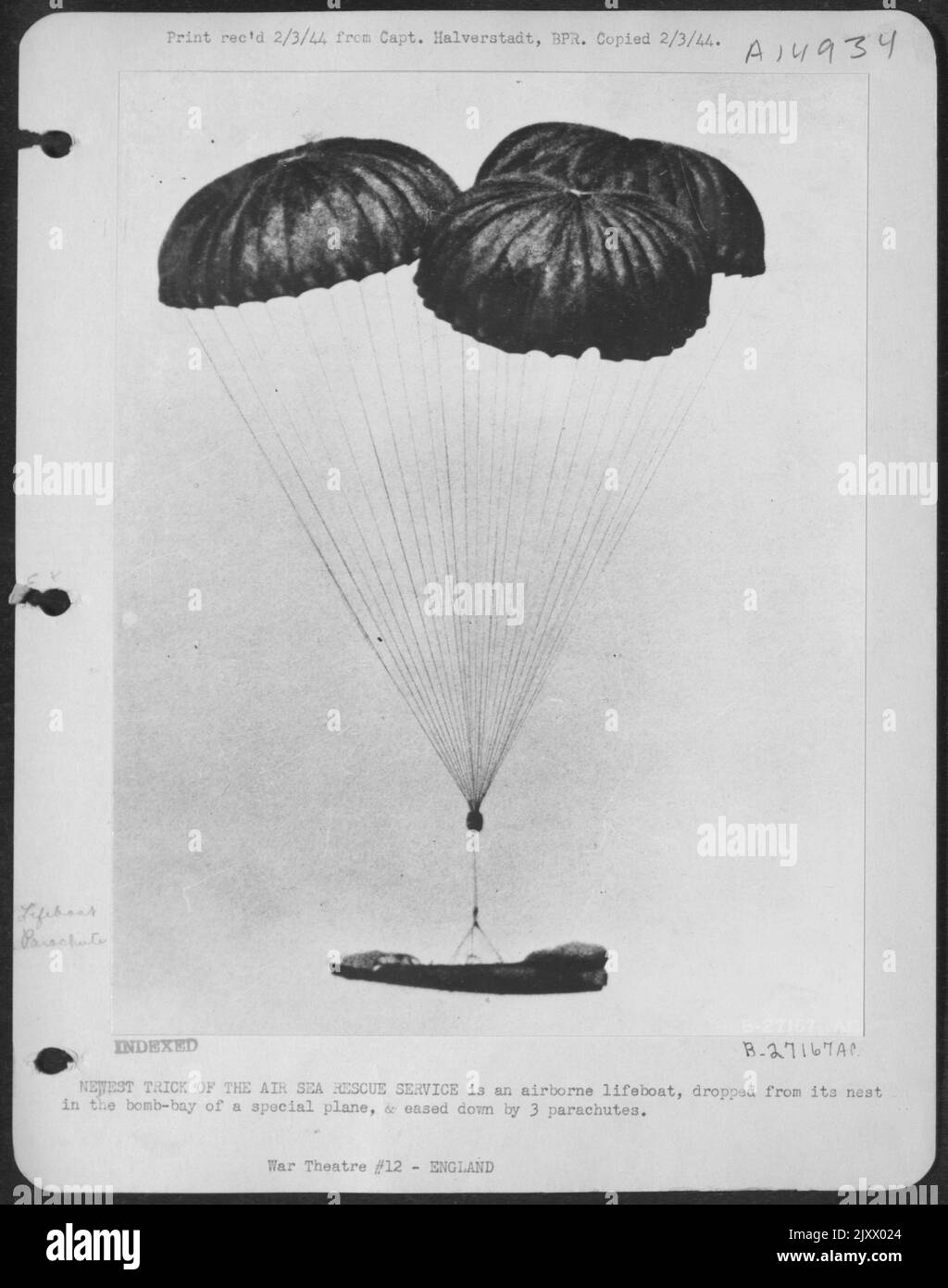 NEWEST TRICK OF THE AIR SEA RESCUE SERVICE is an airborne lifeboat, dropped from its nest in the bomb-bay of a special plane, & eased down by 3 parachutes. Stock Photo