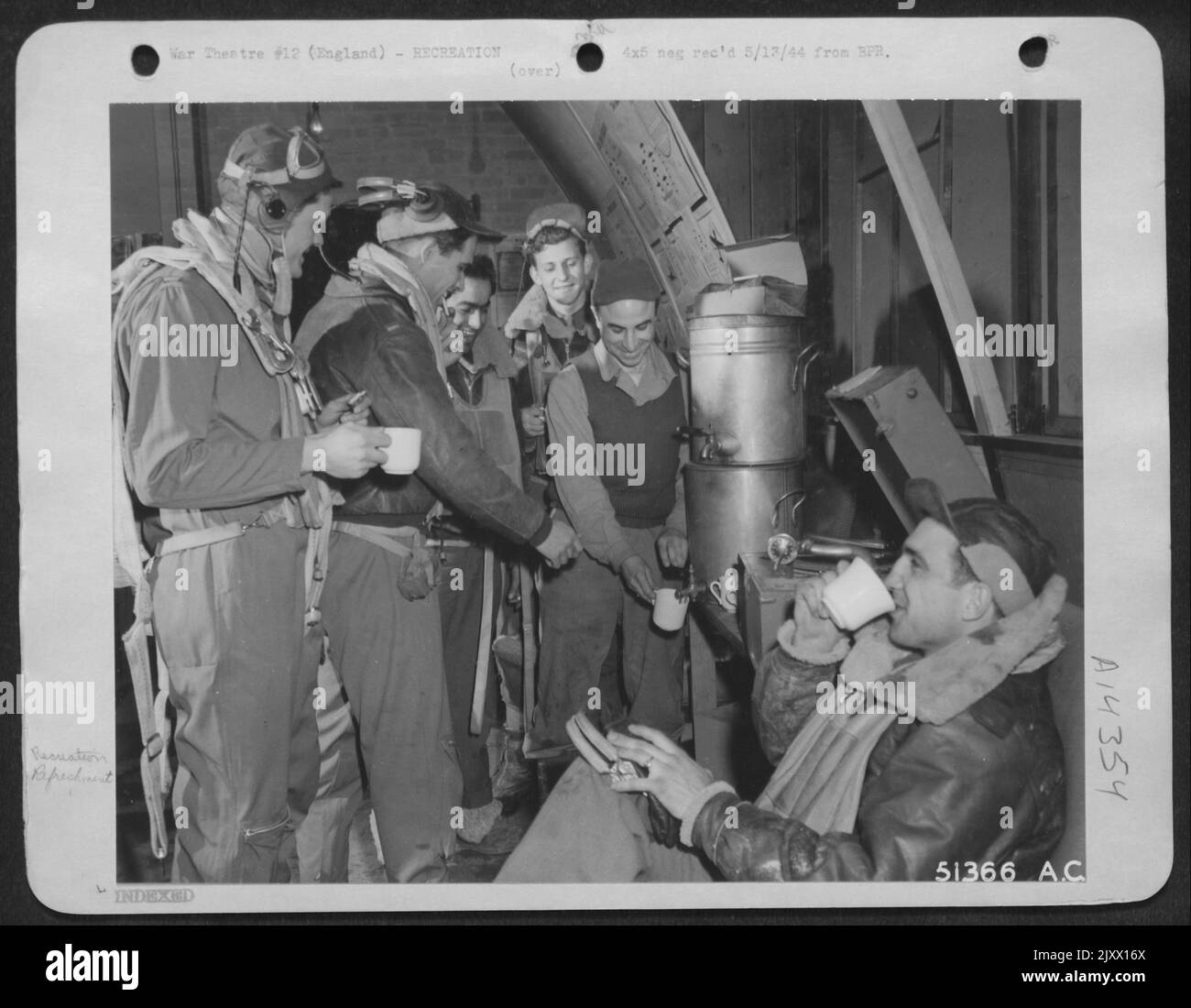 In fighting togs, these Marauder-men-members of the crew of the Martin B-26 Marauder medium bomber, 'Sad Sack' get a final tune-up around the coffee pot in their crew room. Hot coffee and biscuits 'Down the hatch,' these fliers took off a few minutes Stock Photo