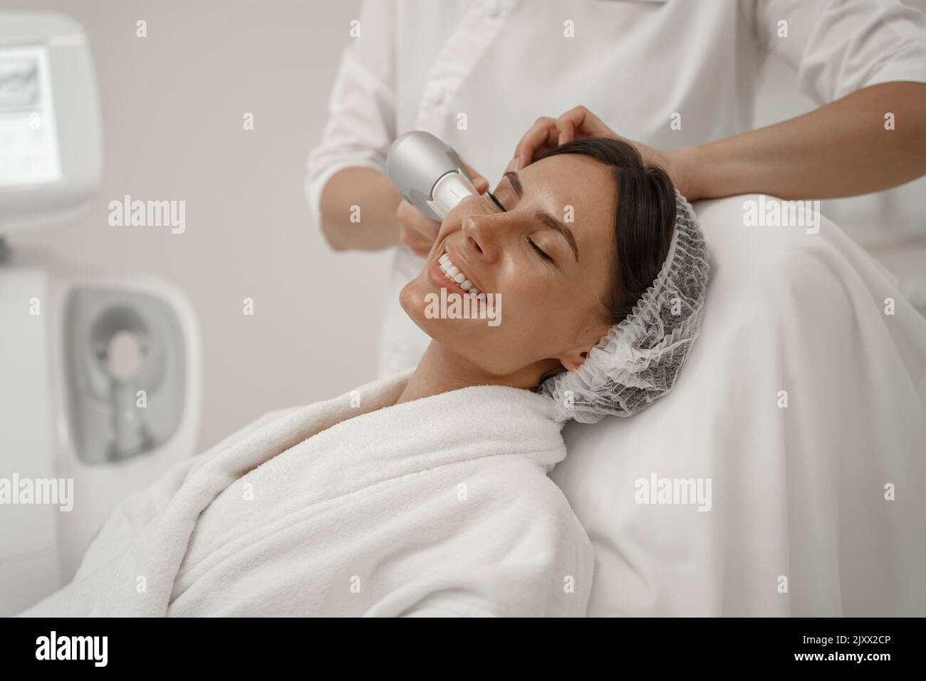 Professional cosmetologist is making cavitation rejuvenation skin treatment. Radio wave lifting Stock Photo