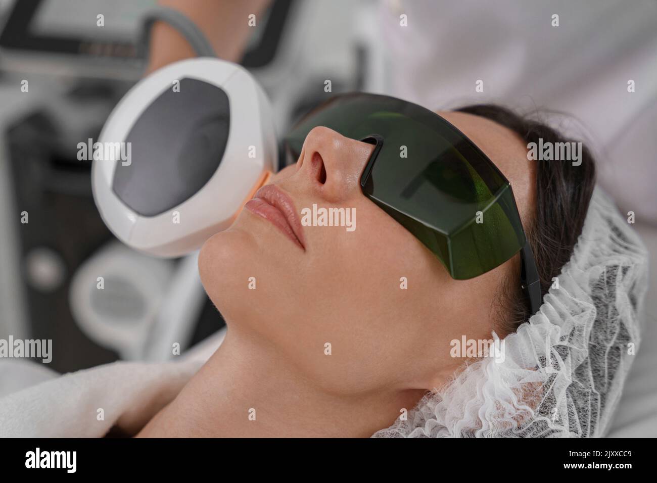 Professional cosmetologist is making cavitation rejuvenation skin treatment. Radio wave lifting Stock Photo