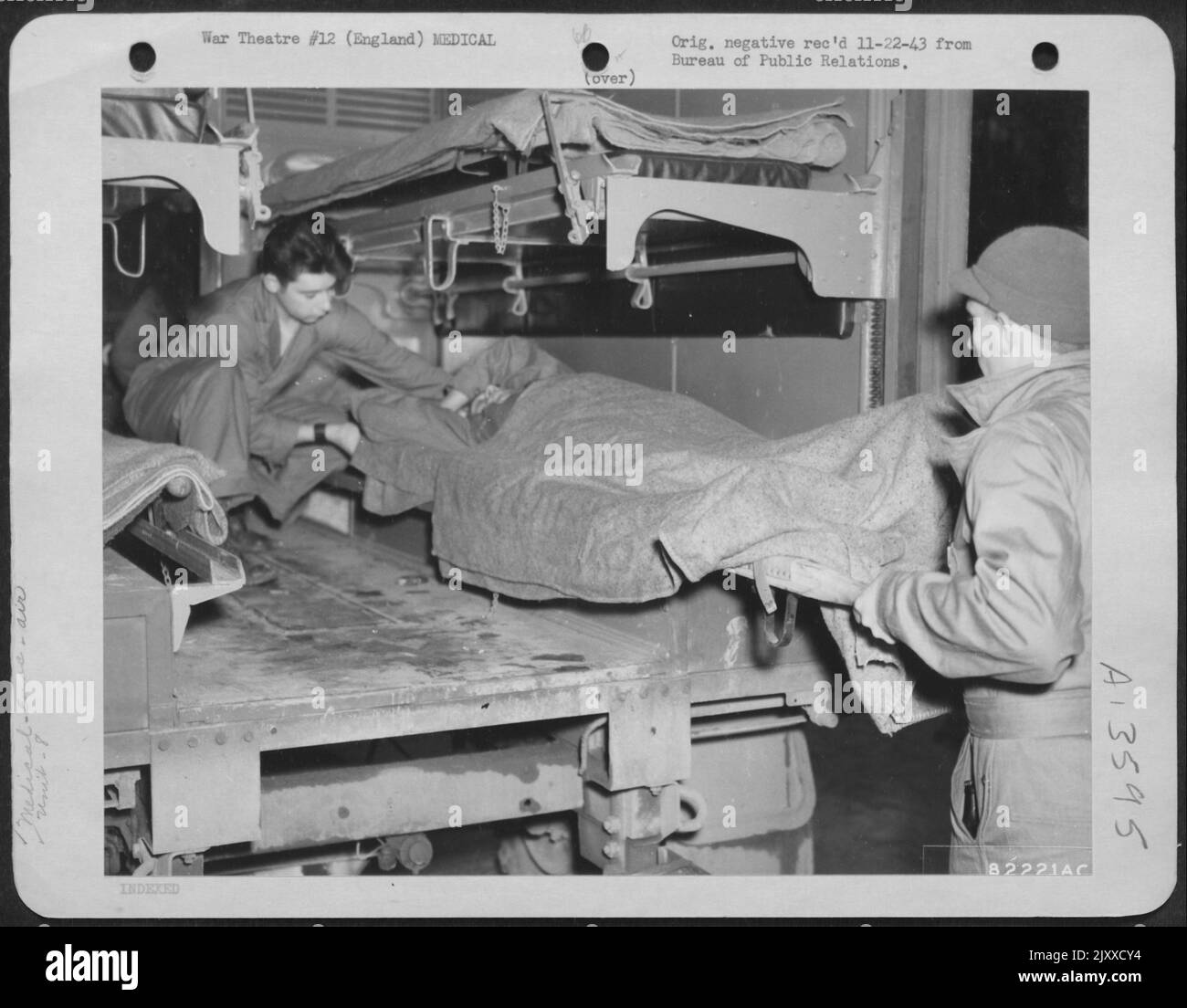 Medical Corpsmen Gently Place A Wounded Member Of The 8Th Bomber Command Aboard A Ambulance At An Air Base Somewhere In England. Stock Photo
