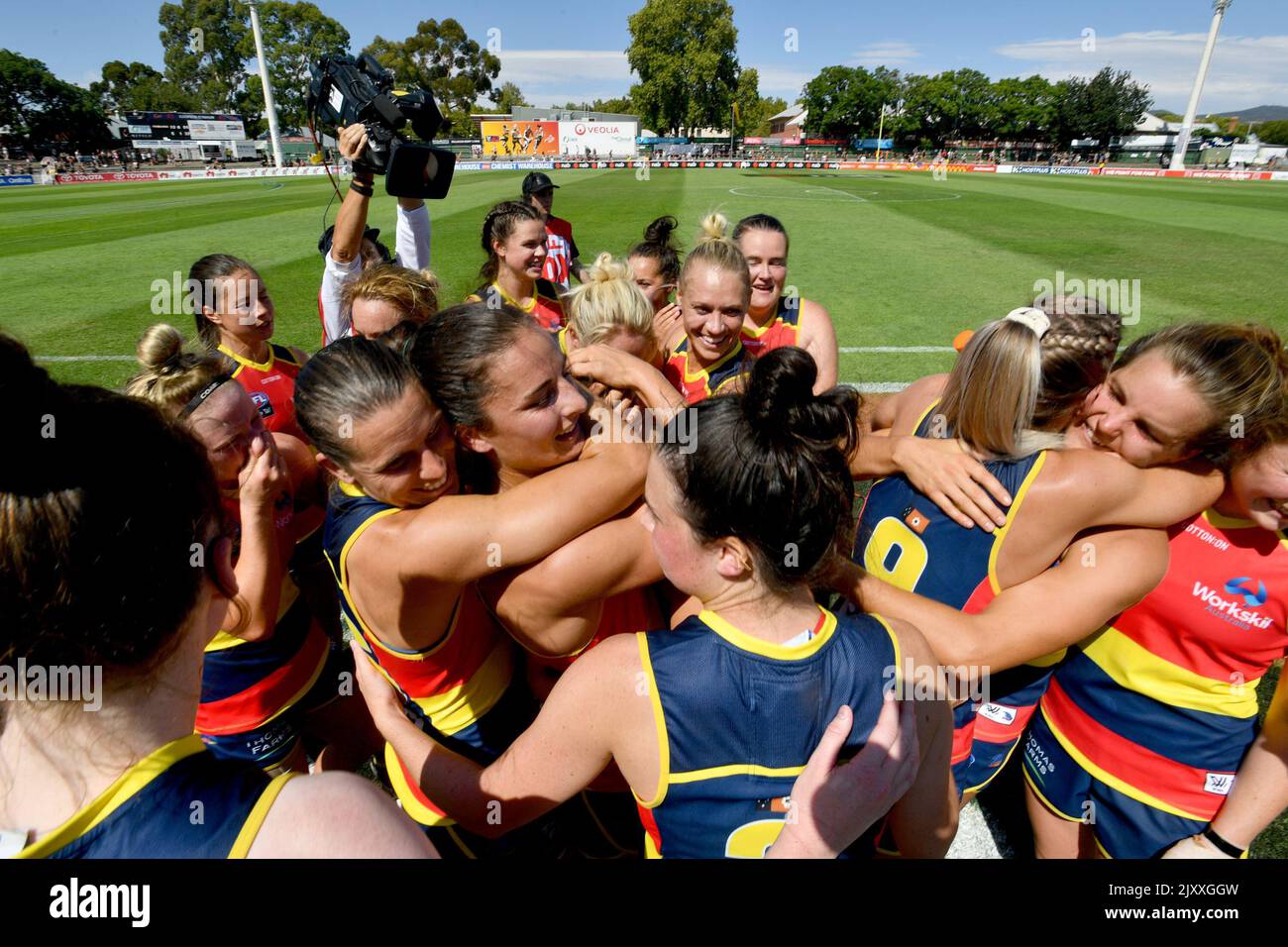 Adelaide Crowos players celebrate after singing their club song following  the Round 3 AFLW match between the Adelaide Crows and the Geelong Cats at  Coopers Stadium in Adelaide, Sunday, February 17, 2019. (