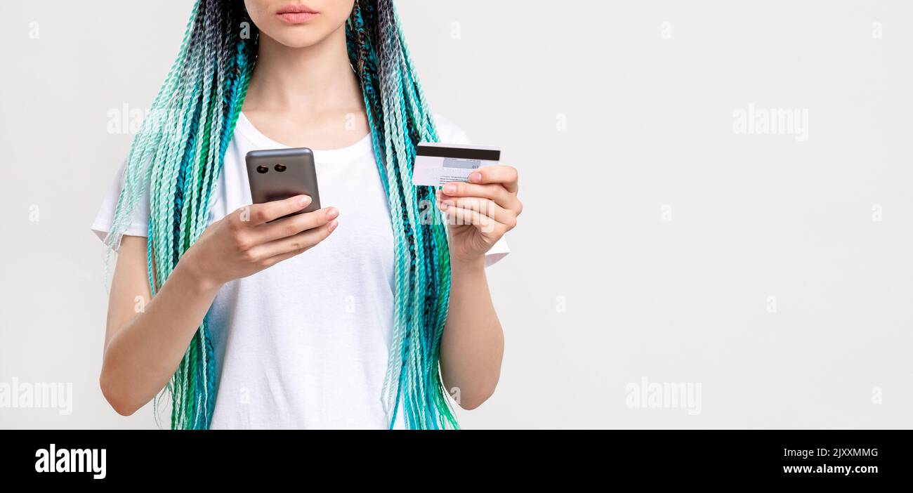 millennial generation woman blue hair braids phone Stock Photo