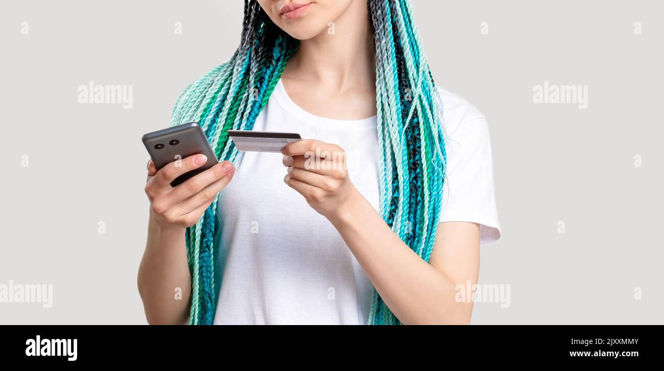 z generation woman blue colored hair braids phone Stock Photo