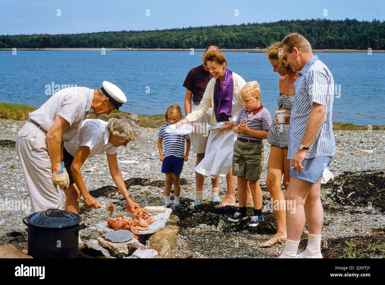 Group of people enjoying a beach picnic with Lobsters, Mt. Desert Island, Maine, USA, Toni Frissell Collection, July 1958 Stock Photo
