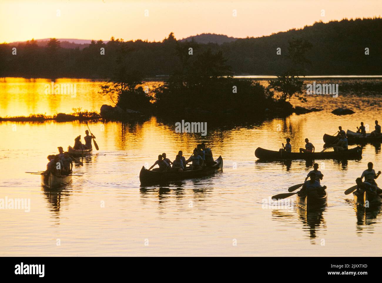 Silhouette of boys in Canoe Boats at Sunset, Camp Sunapee, New Hampshire, USA, Stock Photo