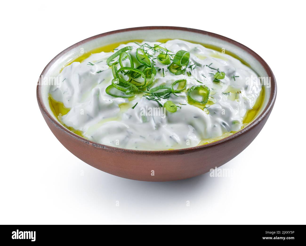 bowl of sour cream or greek yogurt tzatziki sauce isolated on white