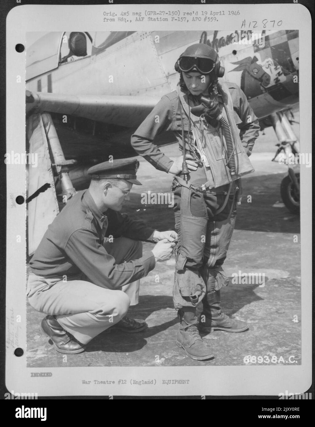 An Officer From The Personal Equipment Office Inspects The G-Suit Worn By A Pilot Of The 353Rd Fighter Group, Based In England. 27 May 1945. Stock Photo