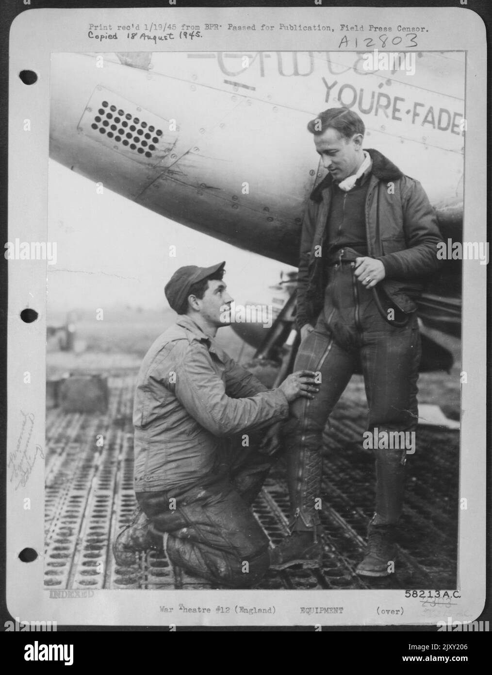 1St Lt. Harry D. Doherty, Left, Personal Equipment Officer For P-51 Mustang Fighter Group Of U.S. 8Th Af, Fits One Of The New Berger G-Suits To 1St Lt. George Rich, Fighter Pilot. The Ingenious Suit Was Designed To Combat 'Black-Outs' In Mid-Air (Airmen' Stock Photo