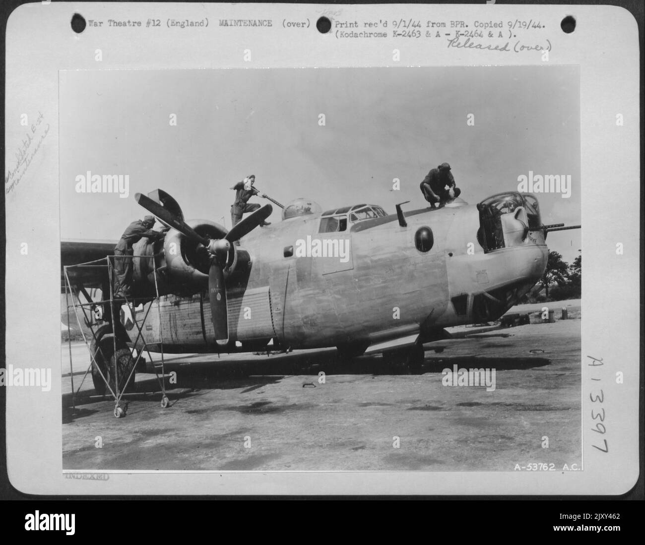 ENGLAND-Ground crew going over a B-24 Liberator with a fine comb after its return from a mission. Stock Photo