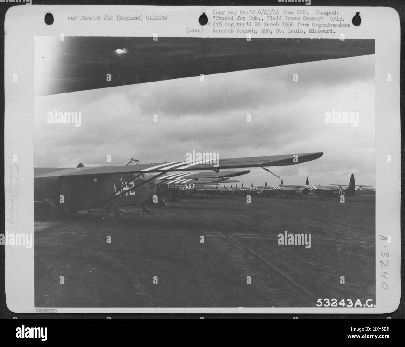 Gliders stretch as far as the eye can see. Both English and American gliders are lined up awaiting Troop Carrier C-47's to tow them into Nazi Europe. England. Stock Photo