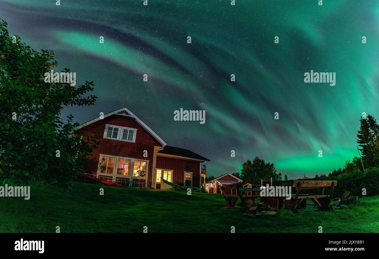 Panorama of dancing Northern lights Aurora borealis in autumn over